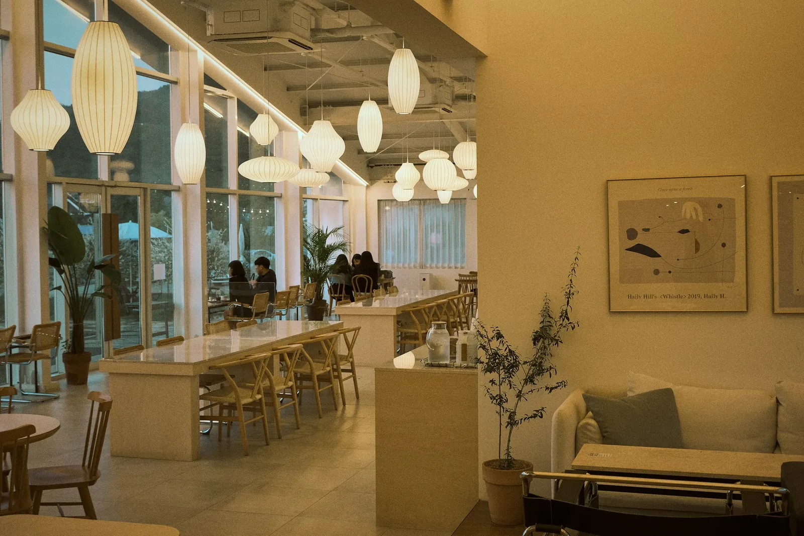 A warm Seoul cafe with paper lanterns and wooden tables